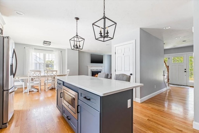 0 Thompson St, Middleboro, MA 02346 - kitchen featuring stainless steel appliances, light wood-style flooring, a chandelier, light countertops, and hanging light fixtures
