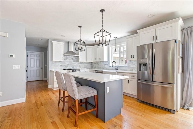 0 Thompson St, Middleboro, MA 02346 - kitchen with appliances with stainless steel finishes, wall chimney exhaust hood, a chandelier, a kitchen island, and white cabinetry