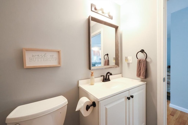 8 Heritage Dr Unit 8, Medway, MA 02053 - half bathroom featuring vanity, toilet, and wood finished floors