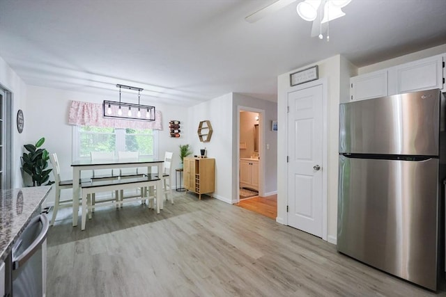 8 Heritage Dr Unit 8, Medway, MA 02053 - kitchen featuring appliances with stainless steel finishes, light wood-style floors, light stone countertops, white cabinetry, and ceiling fan