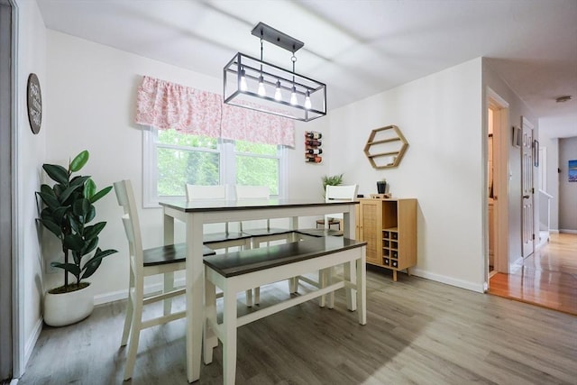 8 Heritage Dr Unit 8, Medway, MA 02053 - dining space with light wood-style flooring, baseboards, and a chandelier