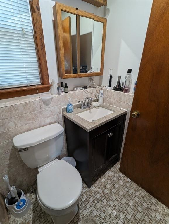 35 Neponset St, Revere, MA 02151 - half bathroom with vanity, tile walls, a wainscoted wall, and toilet