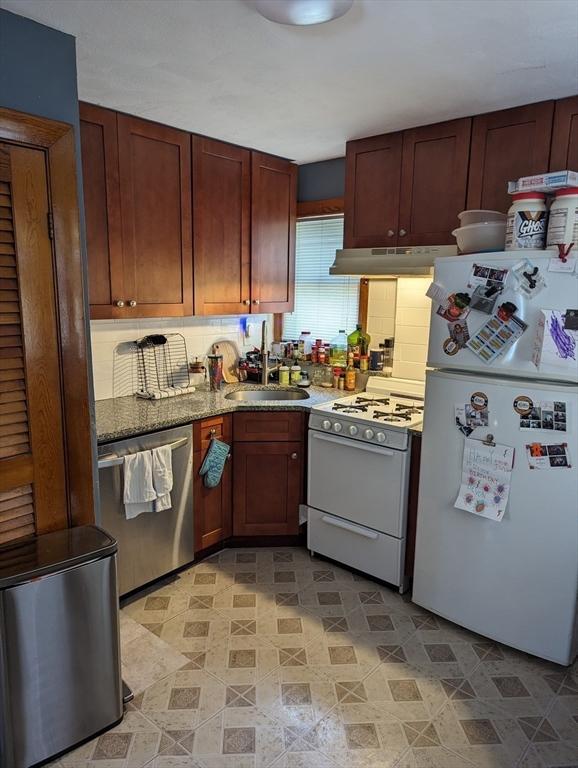 35 Neponset St, Revere, MA 02151 - kitchen with under cabinet range hood, decorative backsplash, a sink, and white appliances
