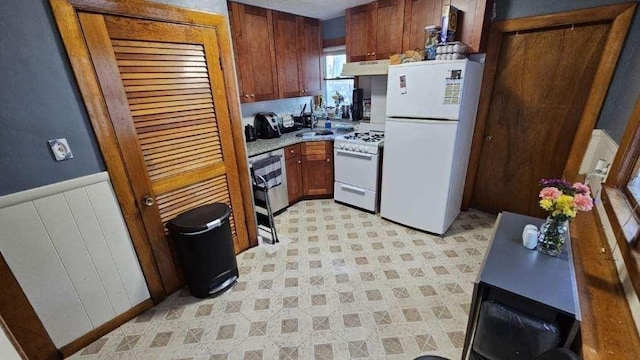 35 Neponset St, Revere, MA 02151 - kitchen with white appliances, light countertops, a wainscoted wall, under cabinet range hood, and a sink