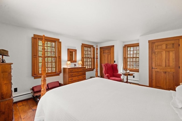 bedroom featuring hardwood / wood-style floors and a baseboard radiator