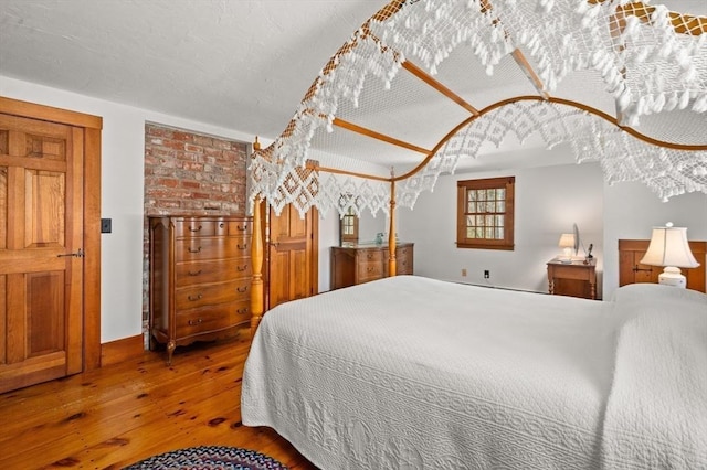 bedroom with hardwood / wood-style flooring