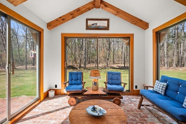 sunroom featuring brick floor and plenty of natural light