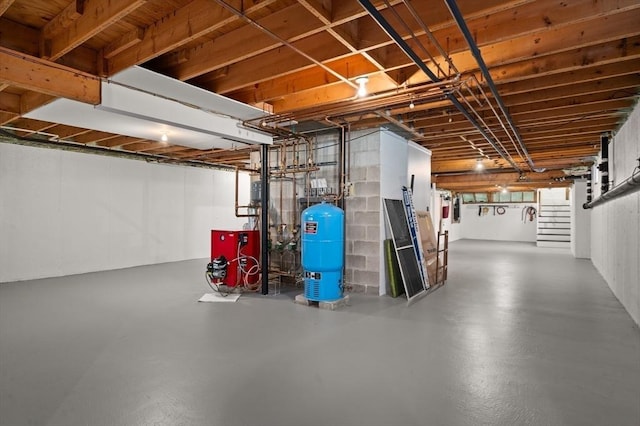 below grade area with stairs and a heating unit