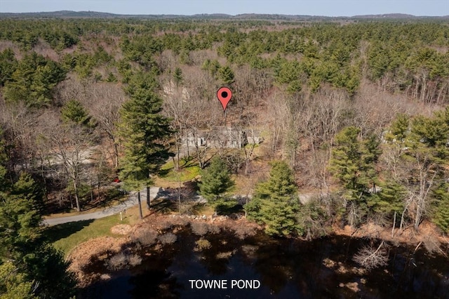 birds eye view of property featuring a forest view