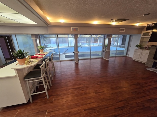 living room with dark hardwood / wood-style flooring and a textured ceiling