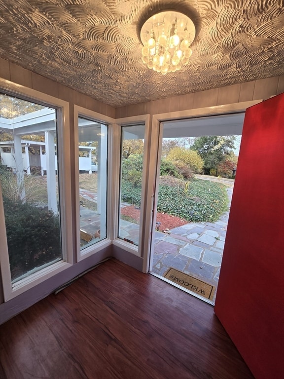 doorway to outside featuring dark wood-type flooring