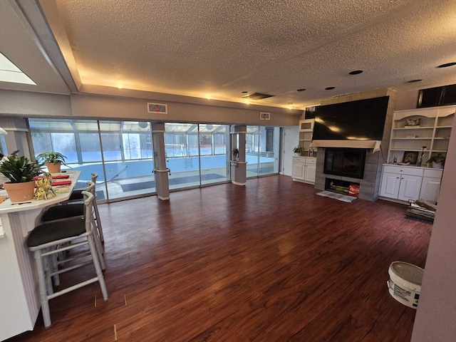 living room with a textured ceiling, french doors, and dark hardwood / wood-style floors