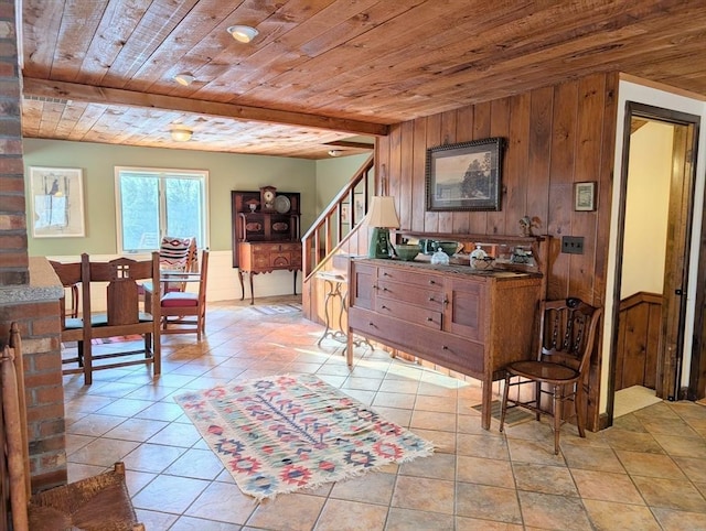 interior space with wooden ceiling, stairs, wooden walls, and wainscoting