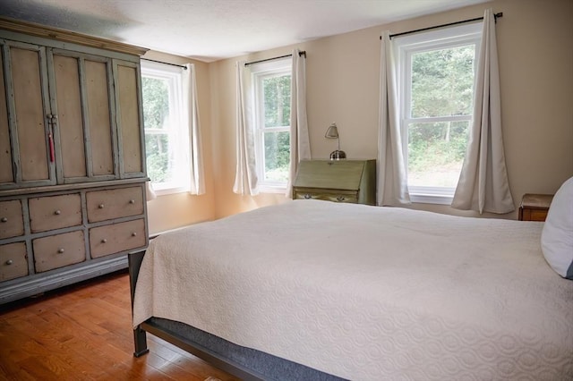 bedroom featuring multiple windows and hardwood / wood-style floors