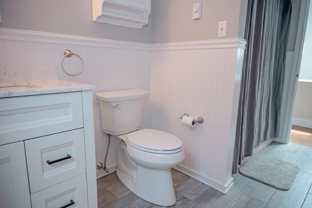 bathroom with vanity, hardwood / wood-style floors, and toilet