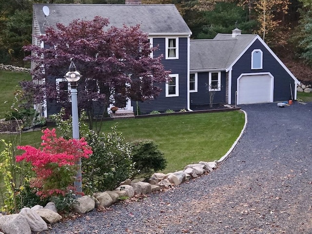 view of front of home with a garage and a front yard