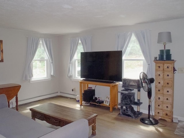 living room featuring a baseboard radiator and light hardwood / wood-style flooring