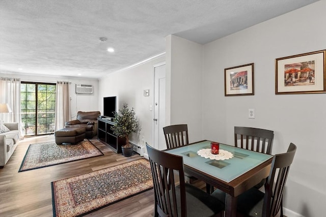 358 Broadway Unit 20, Lynn, MA 01904 - dining room featuring wood finished floors, a wall unit AC, a textured ceiling, and recessed lighting