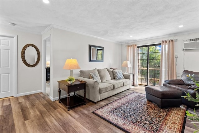358 Broadway Unit 20, Lynn, MA 01904 - living area with wood finished floors, recessed lighting, ornamental molding, baseboards, and a wall unit AC