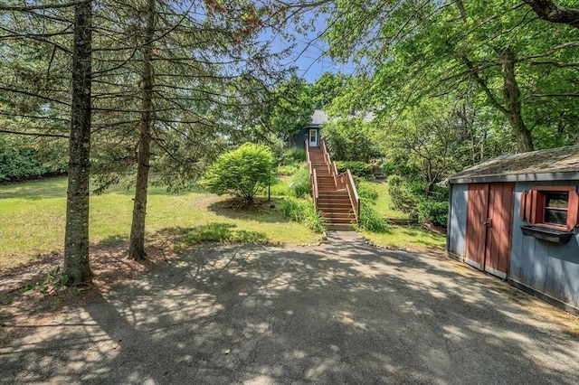 4 3rd Rd, Woburn, MA 01801 - view of grassy yard featuring a storage shed, stairs, and a patio area