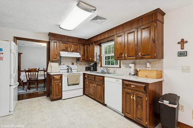 20 Lucia Dr, Milford, MA 01757 - kitchen with white appliances, under cabinet range hood, decorative backsplash, and light flooring