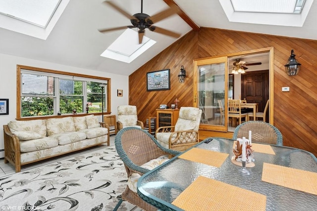 20 Lucia Dr, Milford, MA 01757 - living area featuring a skylight, wood walls, ceiling fan, and lofted ceiling