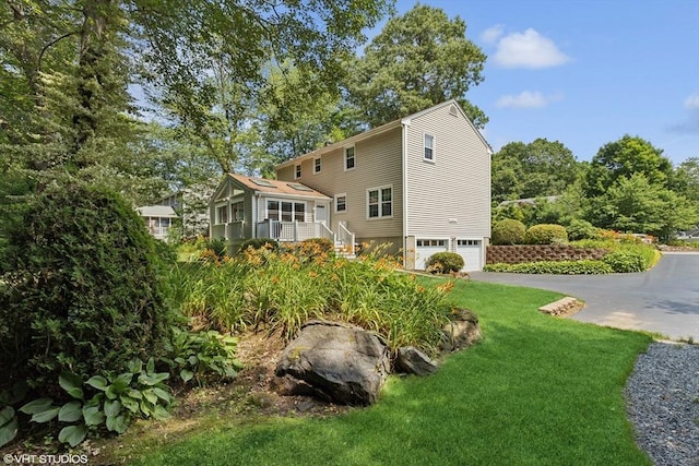 20 Lucia Dr, Milford, MA 01757 - rear view of property featuring a garage, asphalt driveway, and a lawn