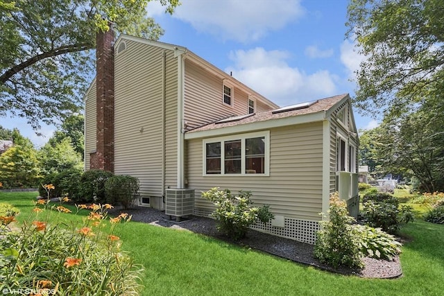 20 Lucia Dr, Milford, MA 01757 - rear view of house with a chimney, a lawn, and solar panels