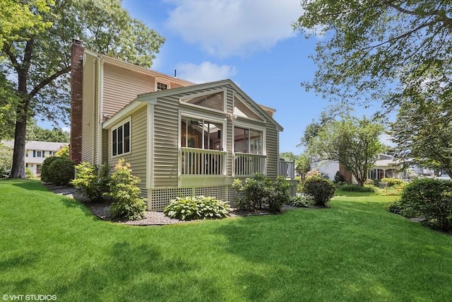 20 Lucia Dr, Milford, MA 01757 - view of side of home with a chimney, a lawn, and a sunroom
