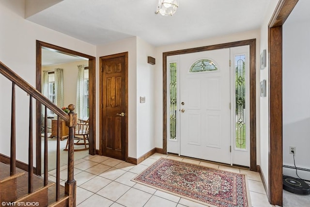 20 Lucia Dr, Milford, MA 01757 - foyer with light tile patterned floors, stairway, and a baseboard radiator