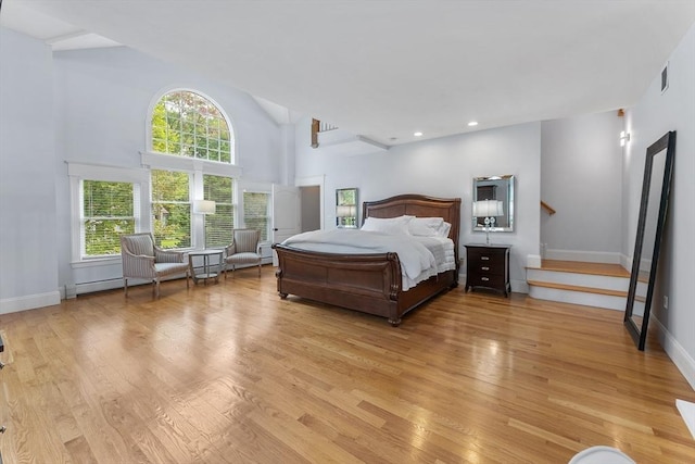 bedroom featuring high vaulted ceiling, visible vents, baseboards, recessed lighting, and light wood-style floors