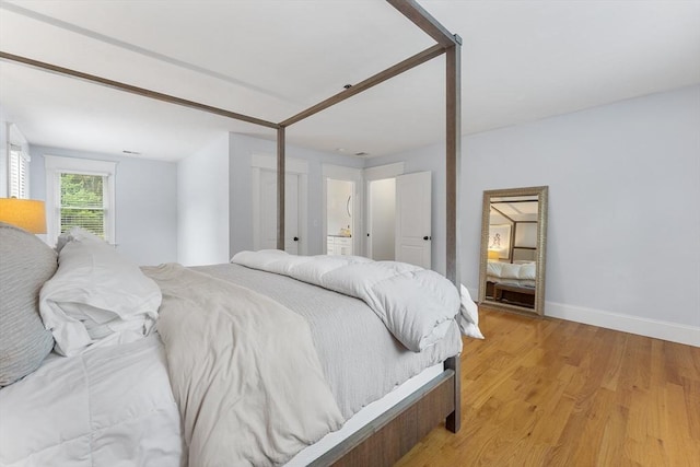 bedroom with baseboards and light wood finished floors