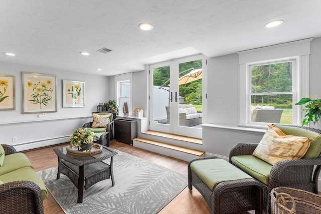 living room featuring recessed lighting, french doors, visible vents, a baseboard radiator, and wood finished floors