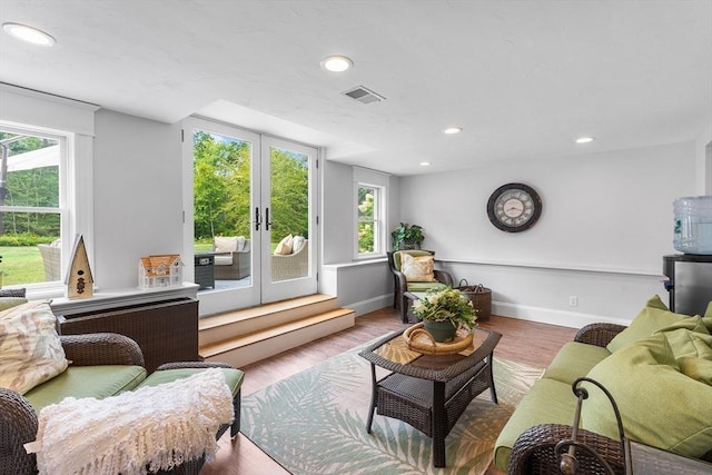 living area with french doors, wood finished floors, baseboards, visible vents, and recessed lighting