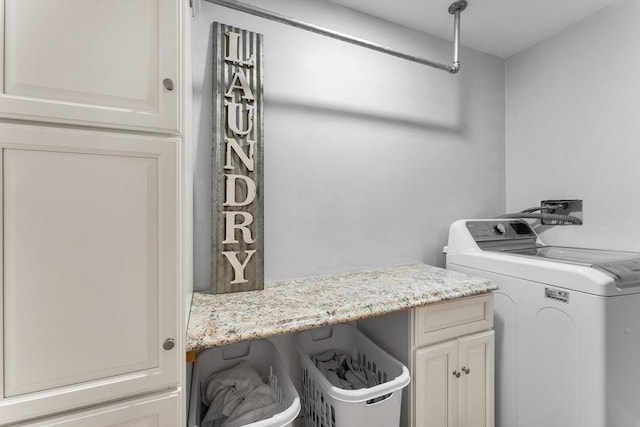 laundry area featuring cabinet space and separate washer and dryer