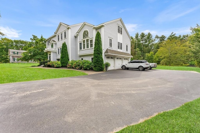 view of property exterior with a lawn, driveway, and a garage
