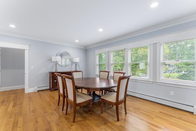 dining area featuring light wood-style flooring, ornamental molding, baseboards, and baseboard heating