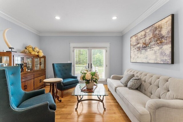 living room with ornamental molding, recessed lighting, and light wood-type flooring