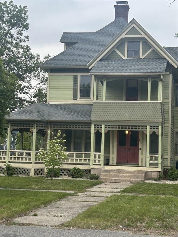 107 Dartmouth, Springfield, MA 01109 - victorian house featuring a shingled roof, a porch, a chimney, a balcony, and a front lawn