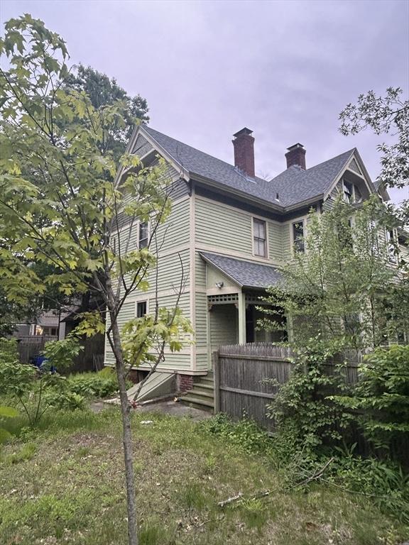 107 Dartmouth, Springfield, MA 01109 - back of property featuring a chimney and a shingled roof