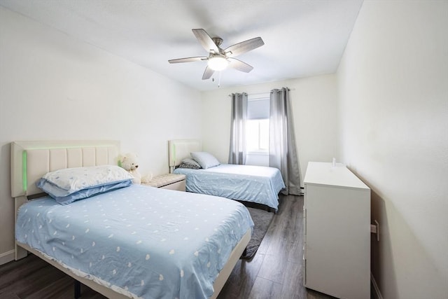 bedroom featuring ceiling fan and dark wood-type flooring