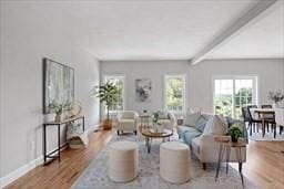 living room featuring beamed ceiling and hardwood / wood-style flooring