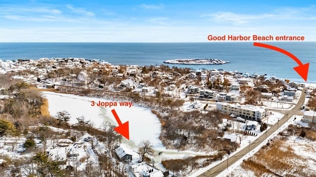 snowy aerial view with a water view