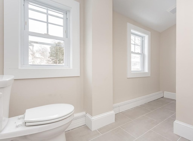 bathroom featuring toilet and tile patterned flooring