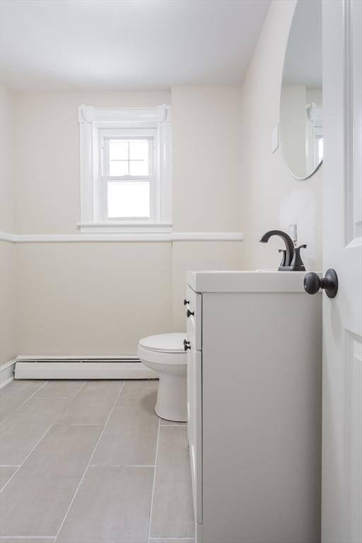 bathroom featuring vanity, tile patterned flooring, a baseboard radiator, and toilet