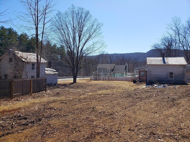 view of yard featuring an outdoor structure and fence