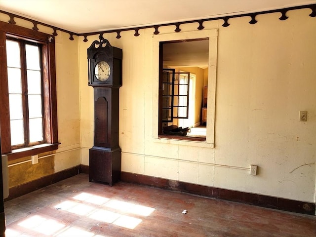 unfurnished room with wood finished floors and baseboards