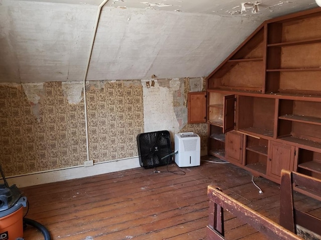 bonus room with hardwood / wood-style flooring and lofted ceiling