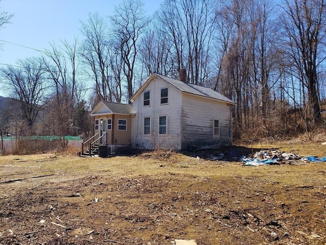 exterior space featuring a chimney and entry steps