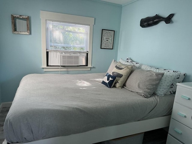 bedroom featuring cooling unit and wood finished floors